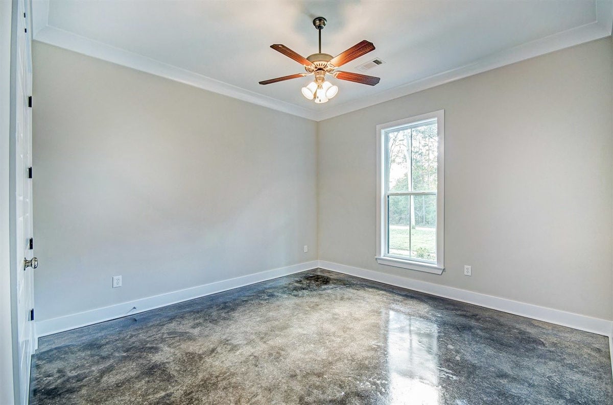 Bedroom 3 with a smaller window, beige walls, and marble flooring.