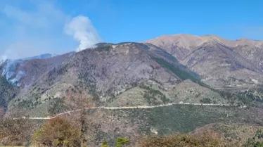 A mountain range with smoke coming out of it

Description automatically generated