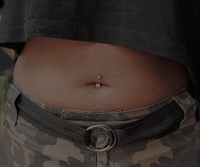 A person with a piercing on their belly

Description automatically generated