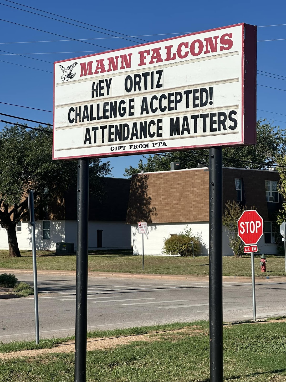 Mann Middle School's marquee sign that reads, "Hey, Ortiz. Challenged accepted! Attendance matters."