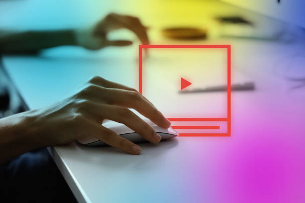Hand on computer mouse hovering to click, representing clickbait headline psychology at work