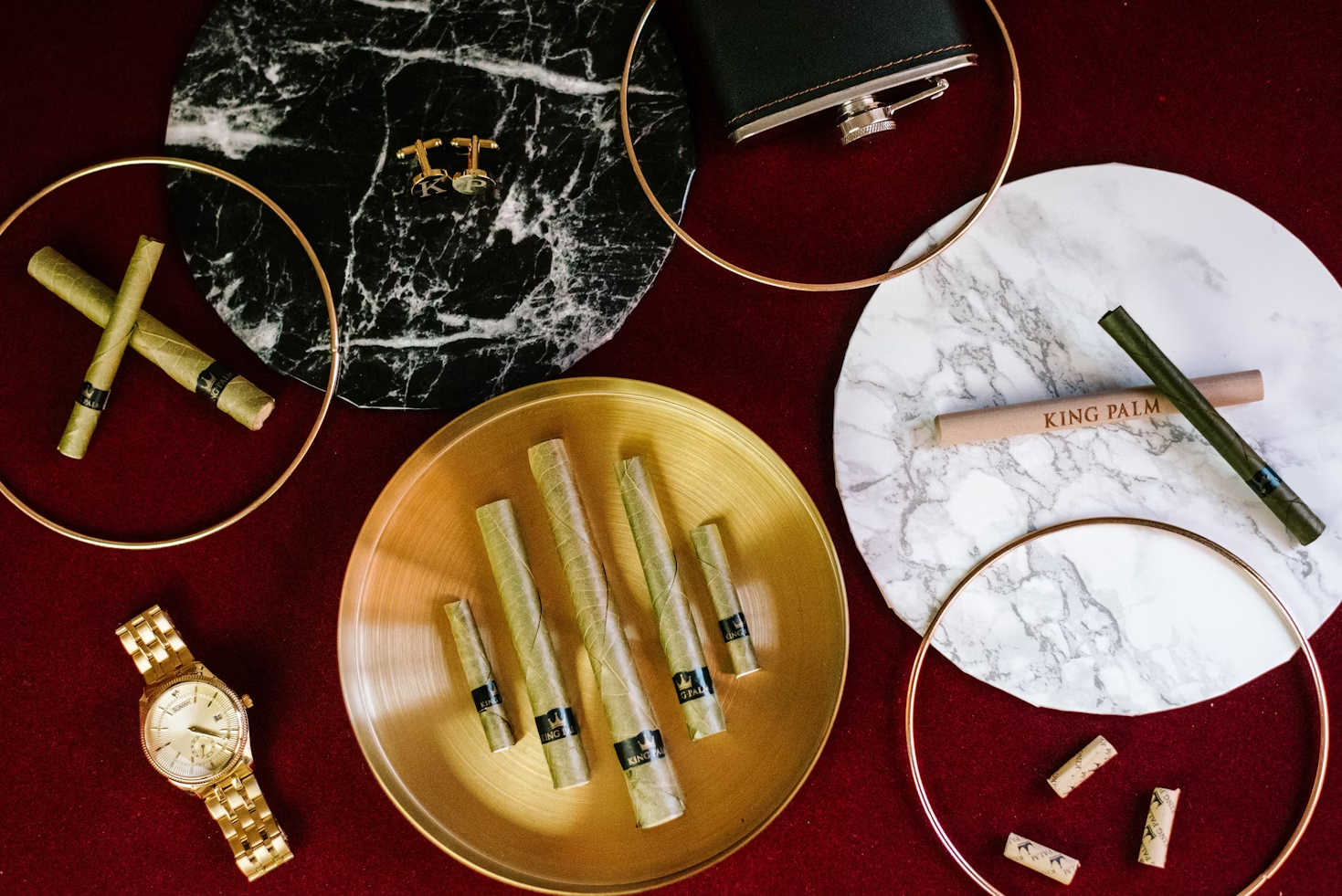 Valuables including a watch laying on a cloth.