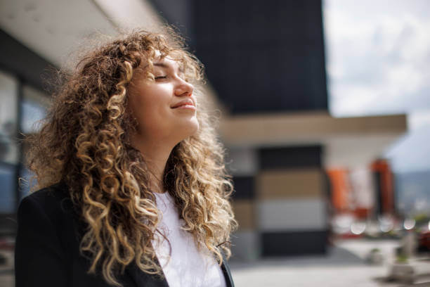 Radiant, stress-free woman smiling confidently, enjoying the benefits of balanced hormones and effective stress management.