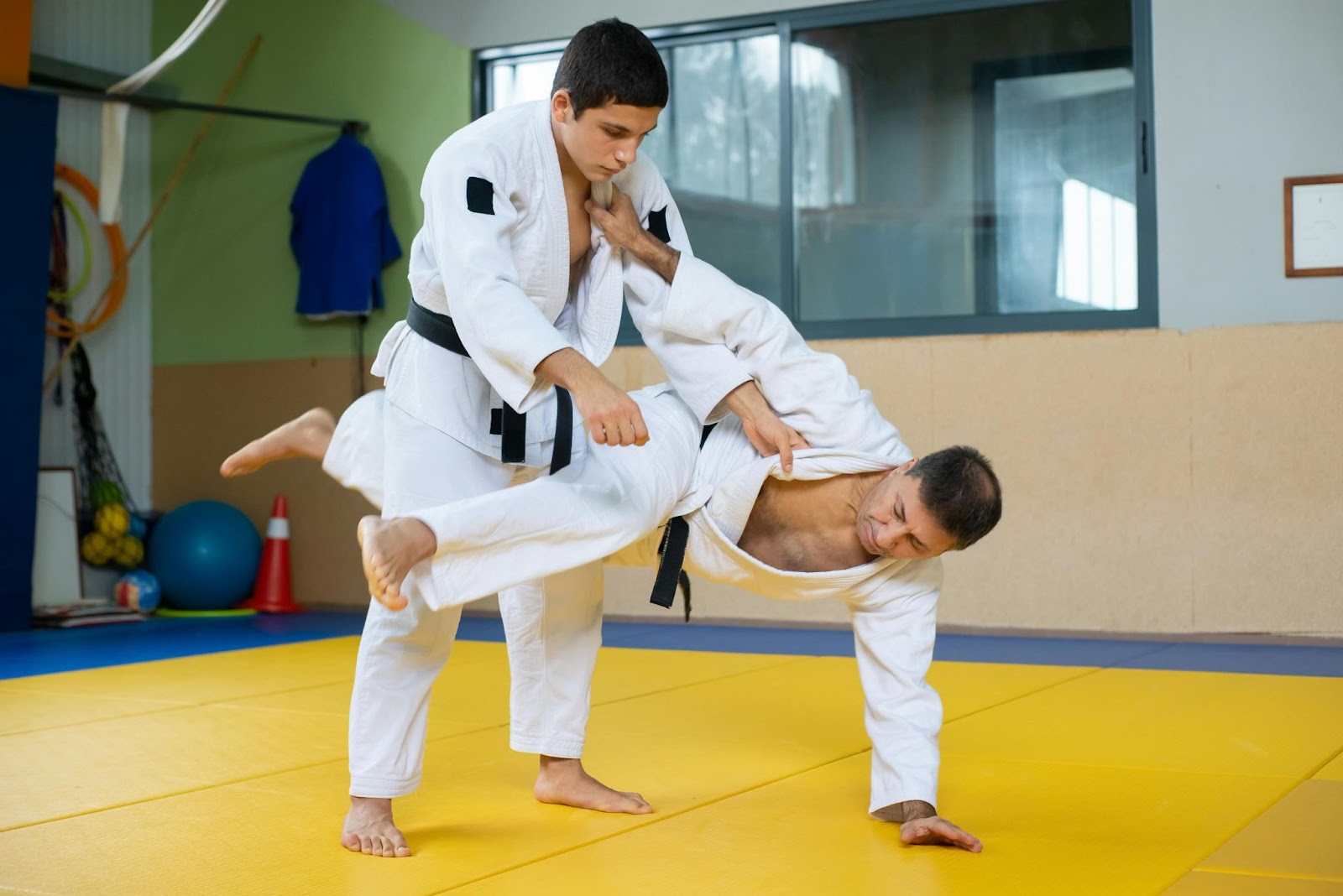 Two martial arts students practicing a falling technique