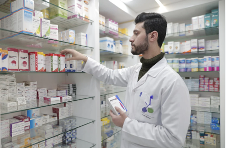 Doctor checking medicines in medical store
