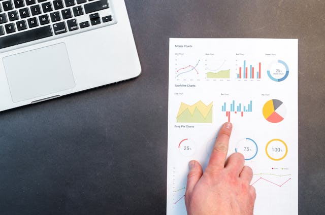 A person analyzing data on a laptop, with charts and graphs, illustrating data-driven decision-making.