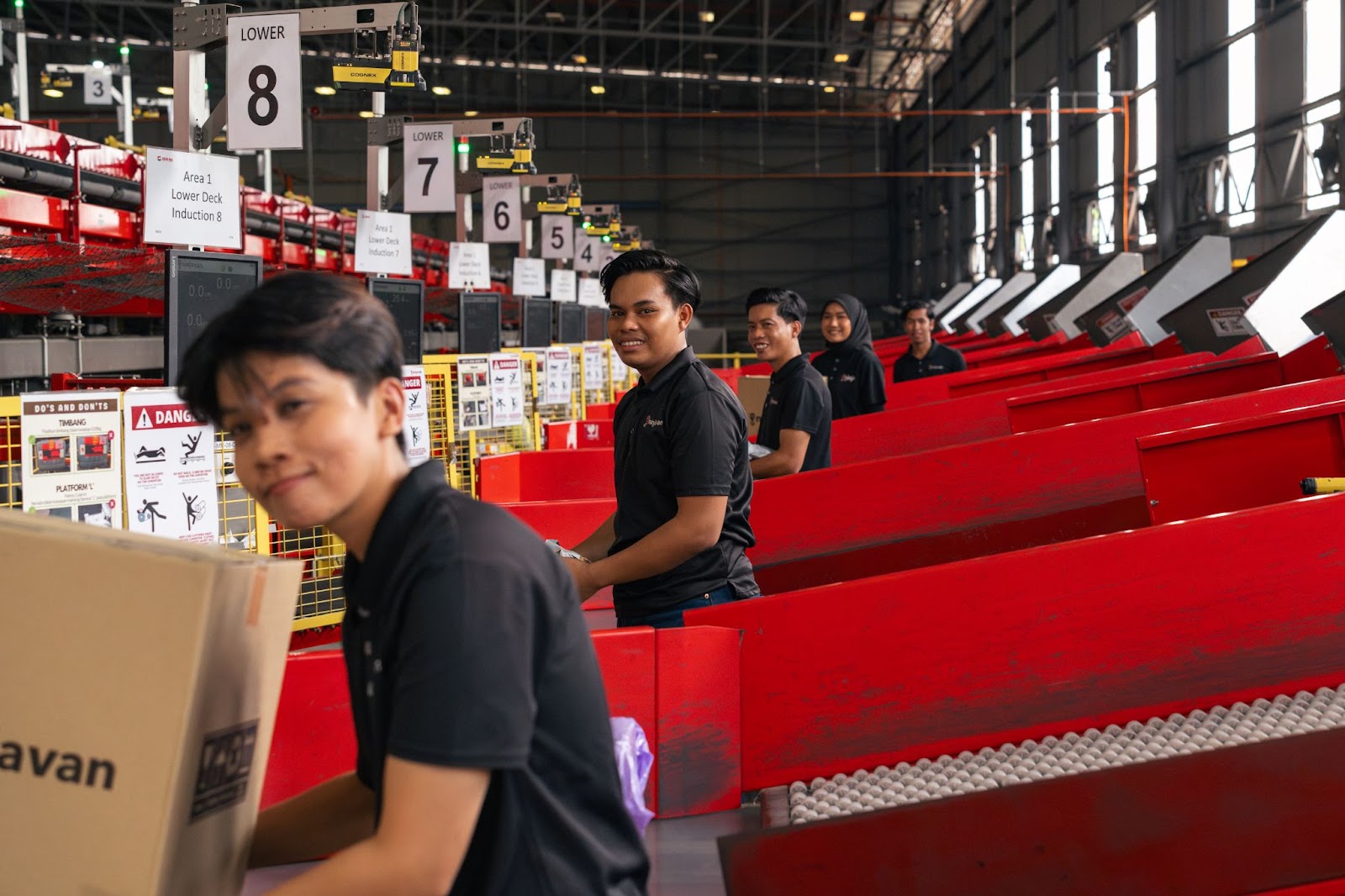 Warehouse employee carefully packing FMCG products into boxes to ensure they arrive in perfect condition.