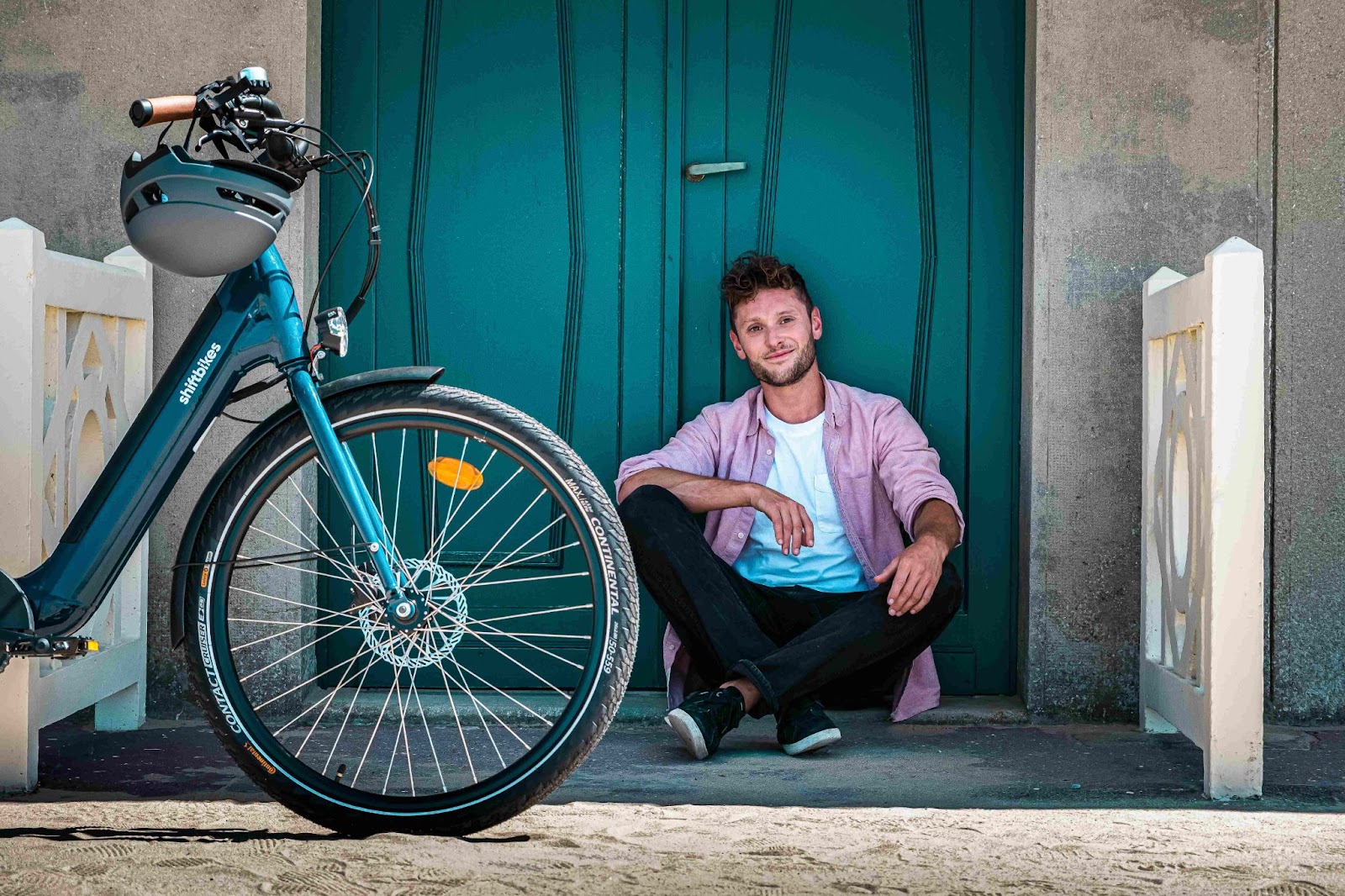 A man taking a break during his cargo bike ride.