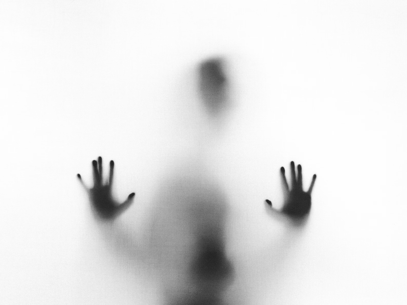 blurred figure behind glass symbolizing brain fog and confusion linked to genetic mental clarity issues