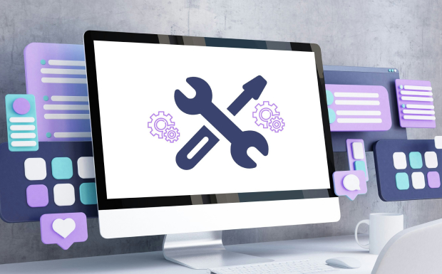 A computer monitor displaying a wrench and screwdriver icon for website maintenance, surrounded by colorful icons representing website design and development tools.