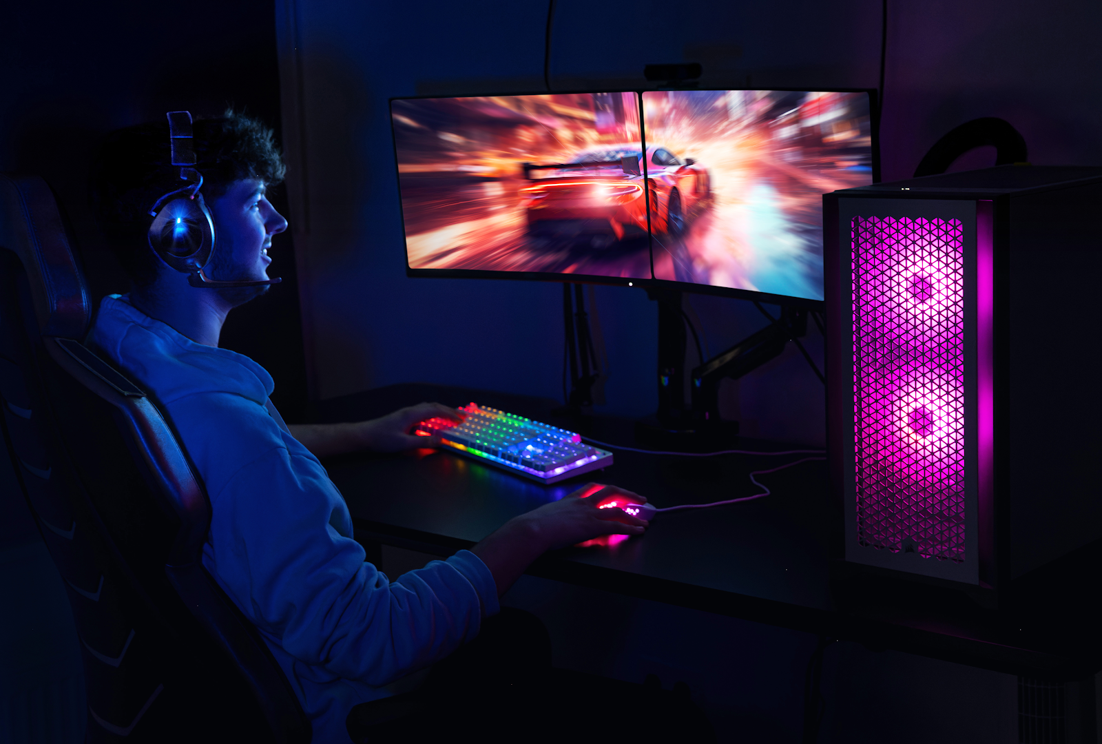 A person sitting at a desk with a computer

Description automatically generated