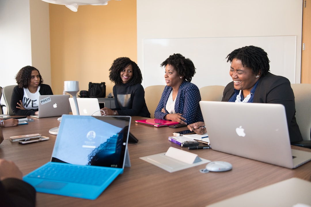 Team members gathered around a table in an office conference room, discussing leveraging real-time analytics for strategic decision-making