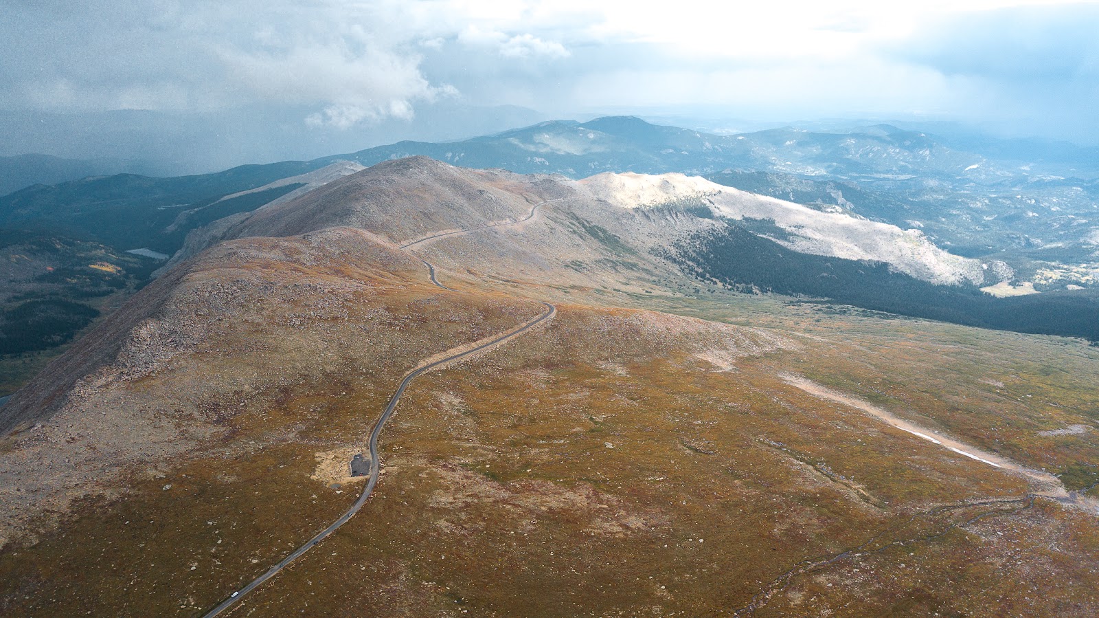 Bike climb Mt. Evans - aerial drone photo just before Summit Lake - roadway and mountains 