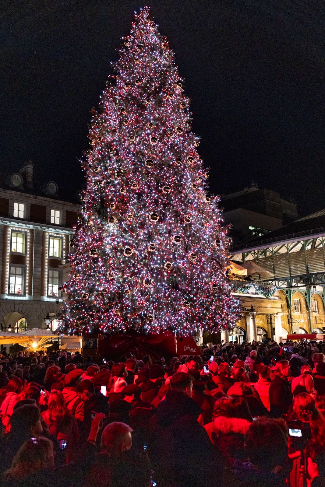 Festive Christmas decorations and holiday displays at Covent Garden in London, featuring a large Christmas tree and seasonal lights