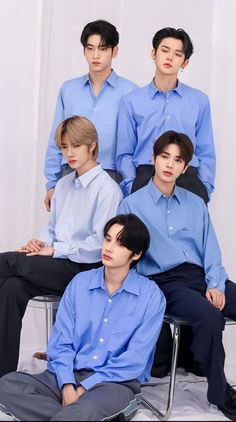 This contain TXT are posing for a photo in blue shirts and black pants