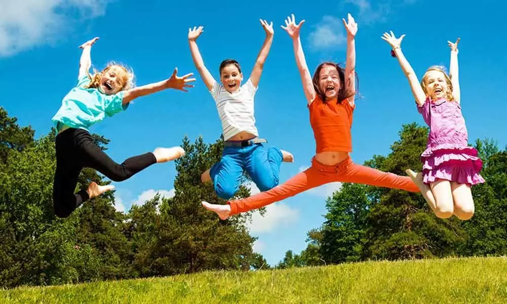 Active children jumping in the air with joy.
