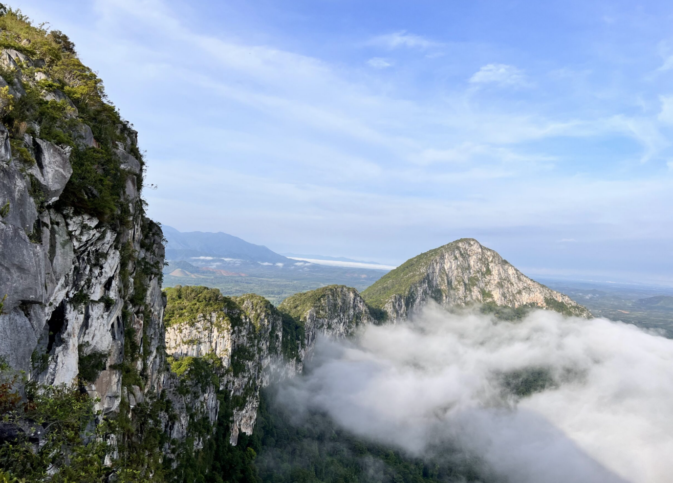 A mountain range with clouds and trees

Description automatically generated with medium confidence