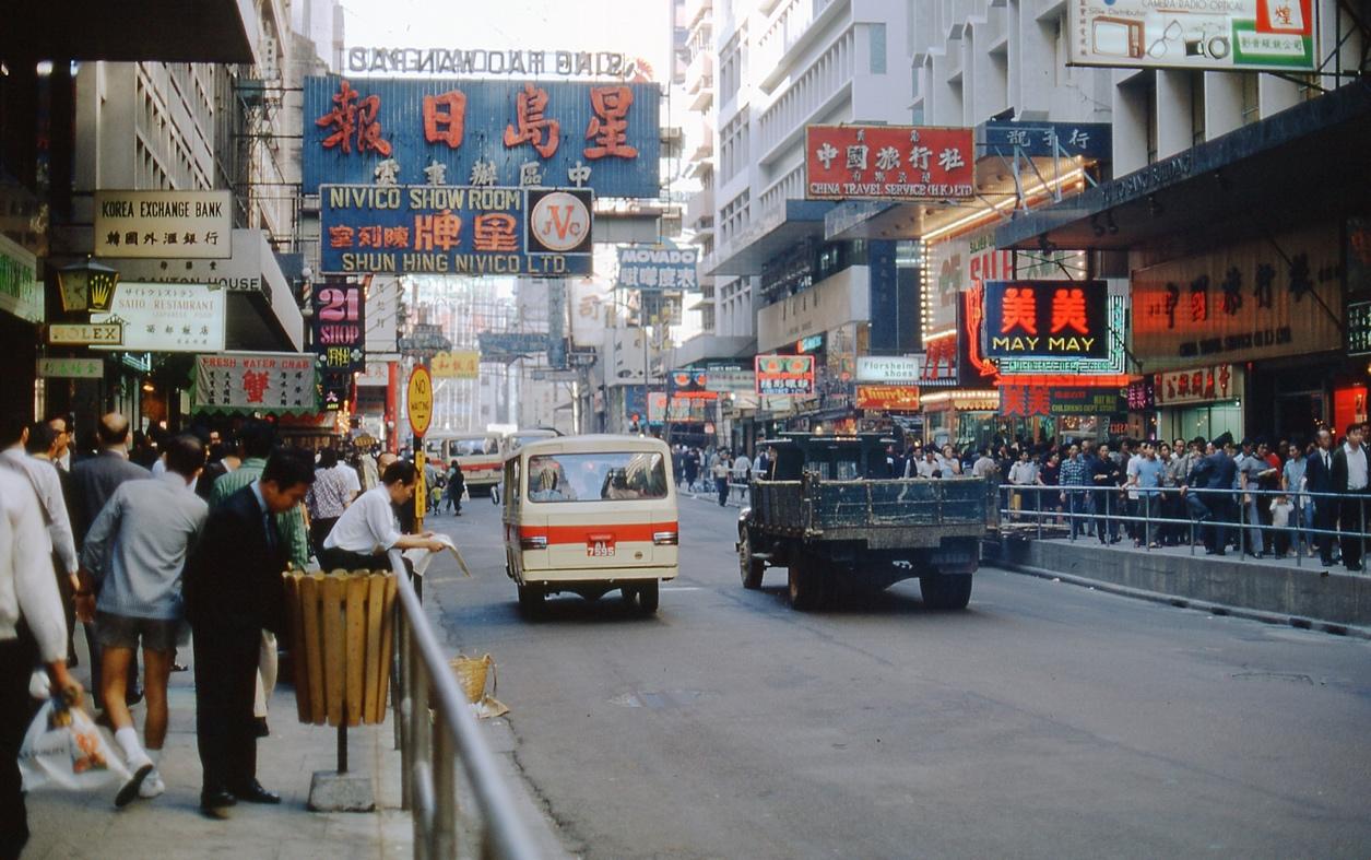 A busy city street with people walking

Description automatically generated