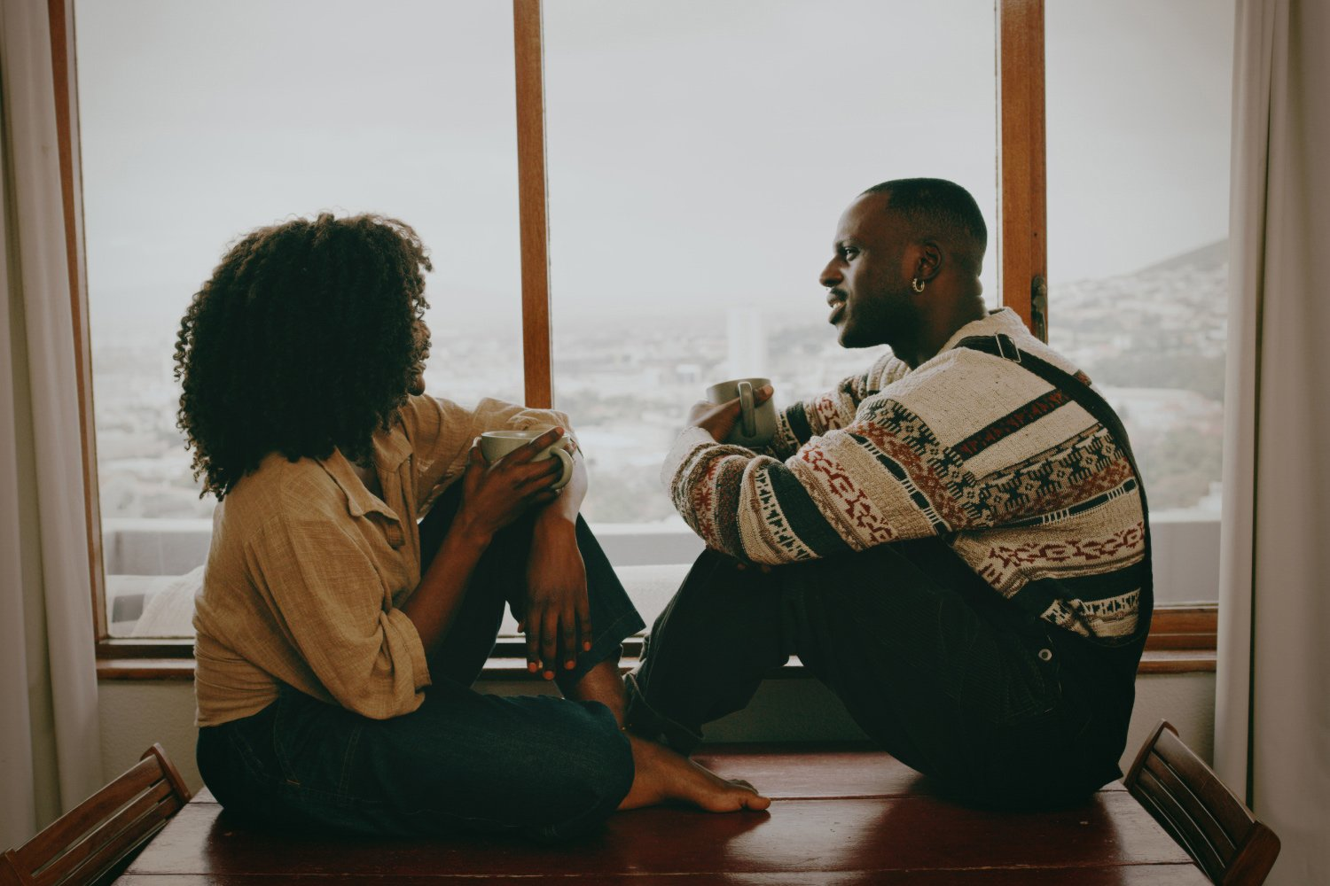 Two couples sitting on the window side and communicating to build a healthy relationship. It is recommended as a best Love and Relationship Guidance. 