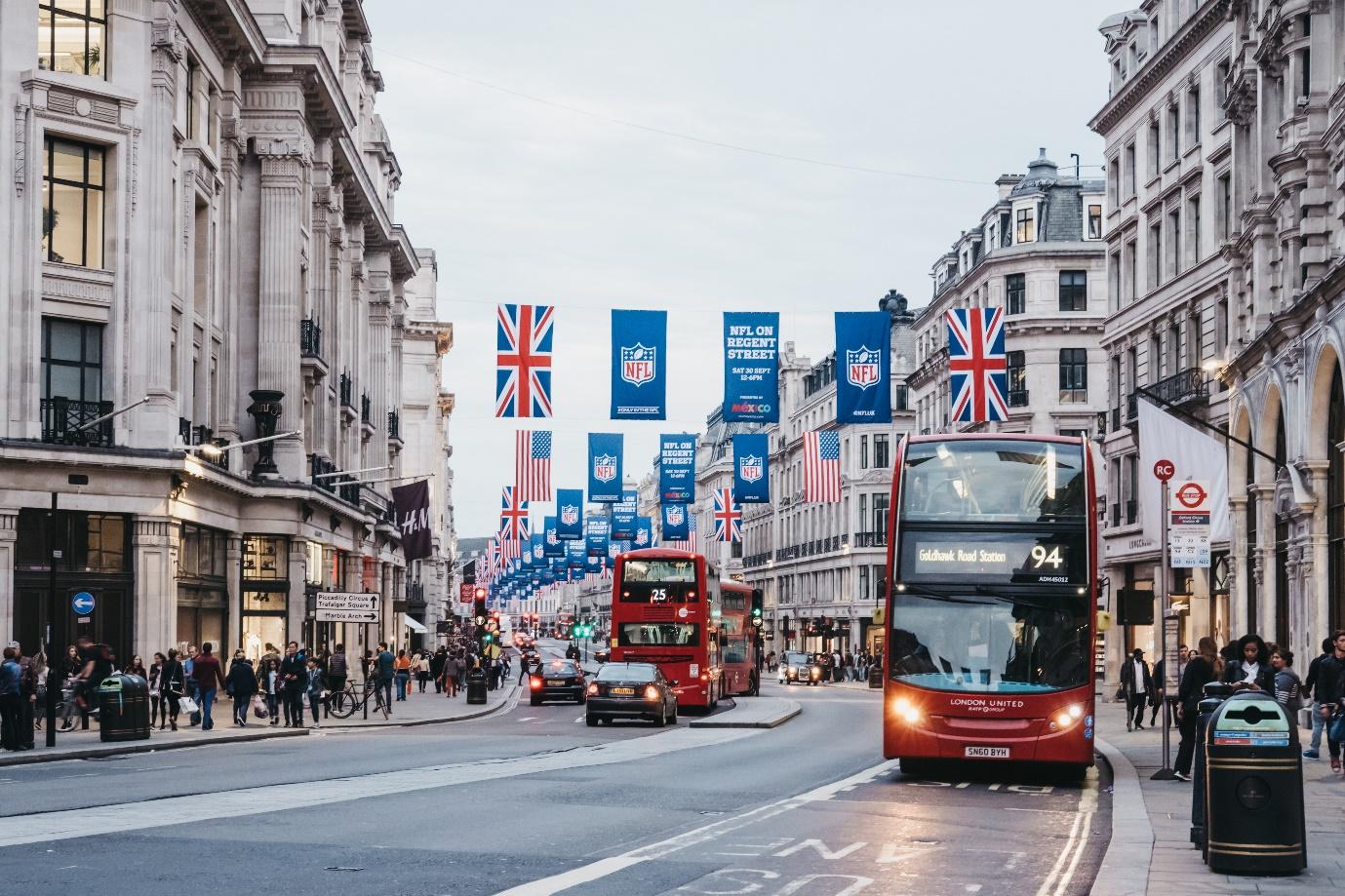 A double decker bus on a street

Description automatically generated