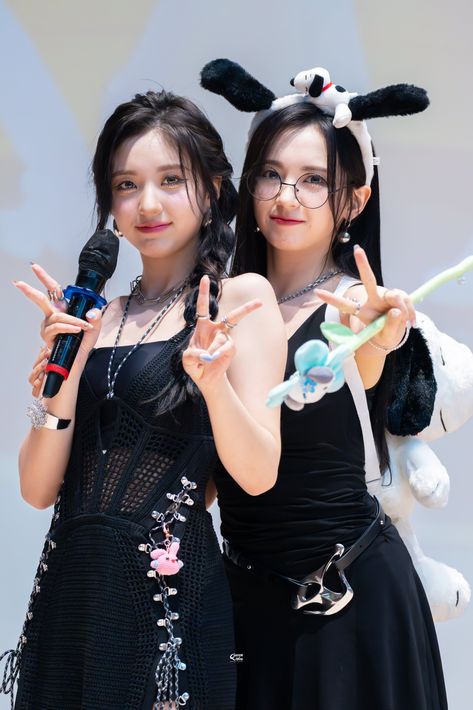 This contain an image of Mashiro and Yeseo dressed in bunny ears and black dresses holding up peace signs while standing next to each other