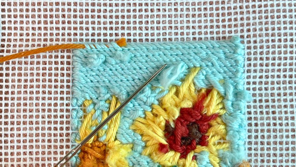 Decorative binding stitch needlepoint featuring yellow flower motifs and fine edge finishing