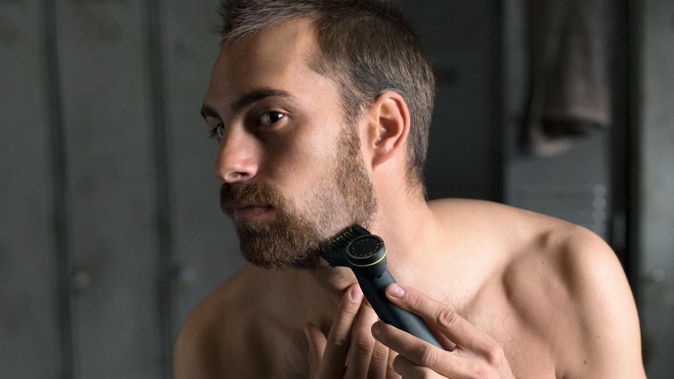 A person shaving his beard

Description automatically generated