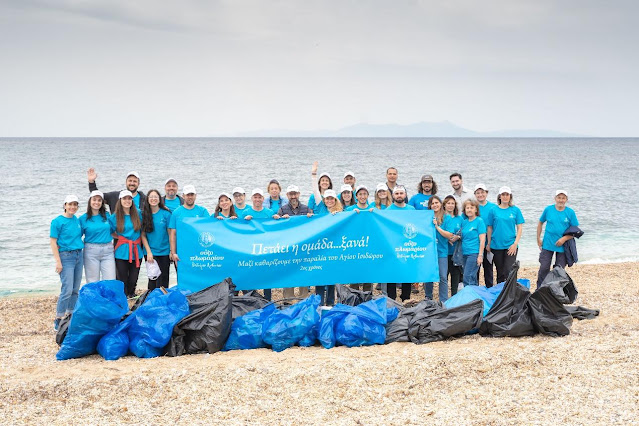 A group of people standing on a beach holding a banner

AI-generated content may be incorrect.