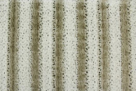 A close-up of a microfiber fabric with an animal print in brown and beige colors.