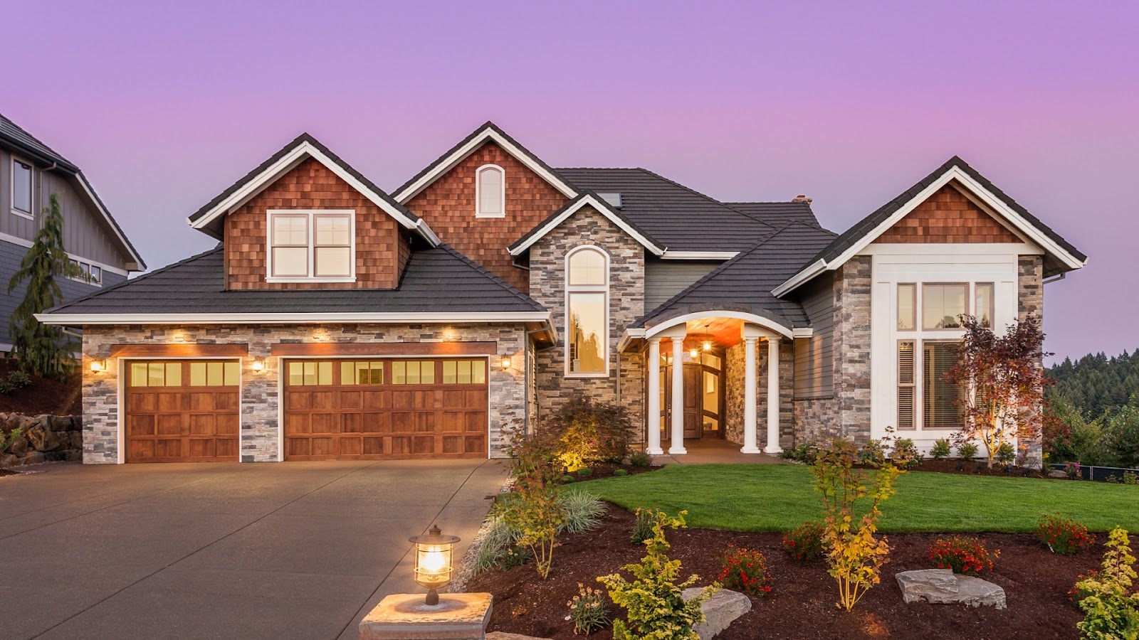 Elegant home showcasing garage door modification with wooden carriage-style doors