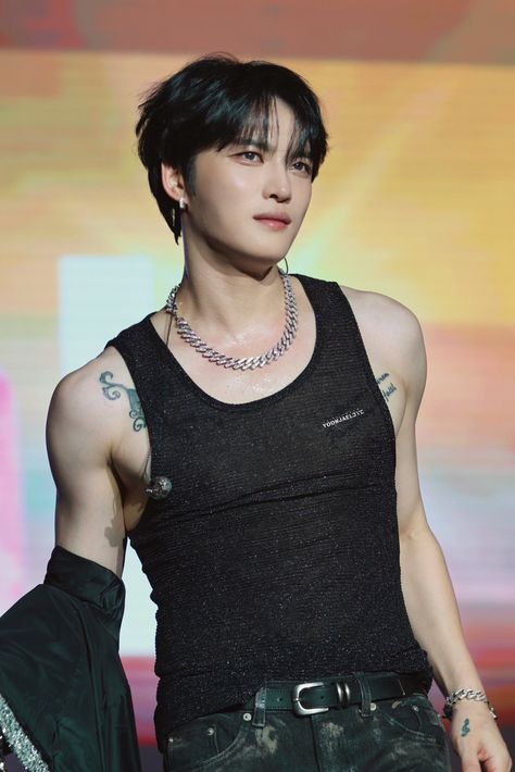 A picture Jaejoong another JYJ member wearing a black singlet 