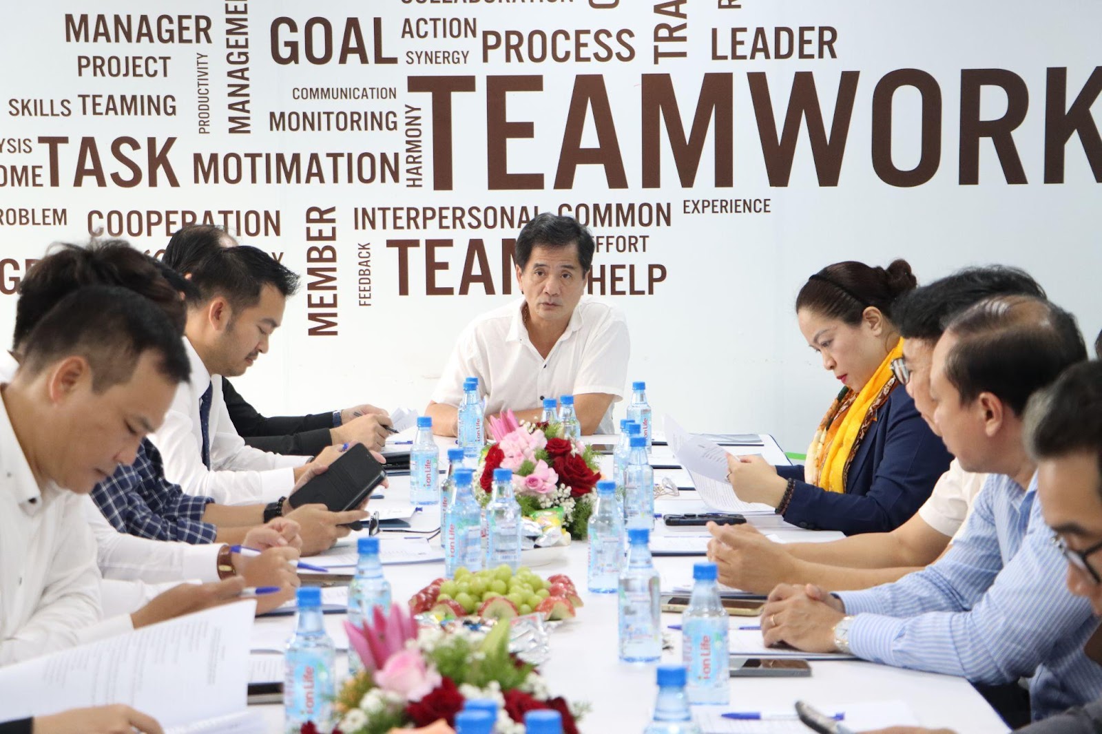 A group of people sitting around a table

Description automatically generated