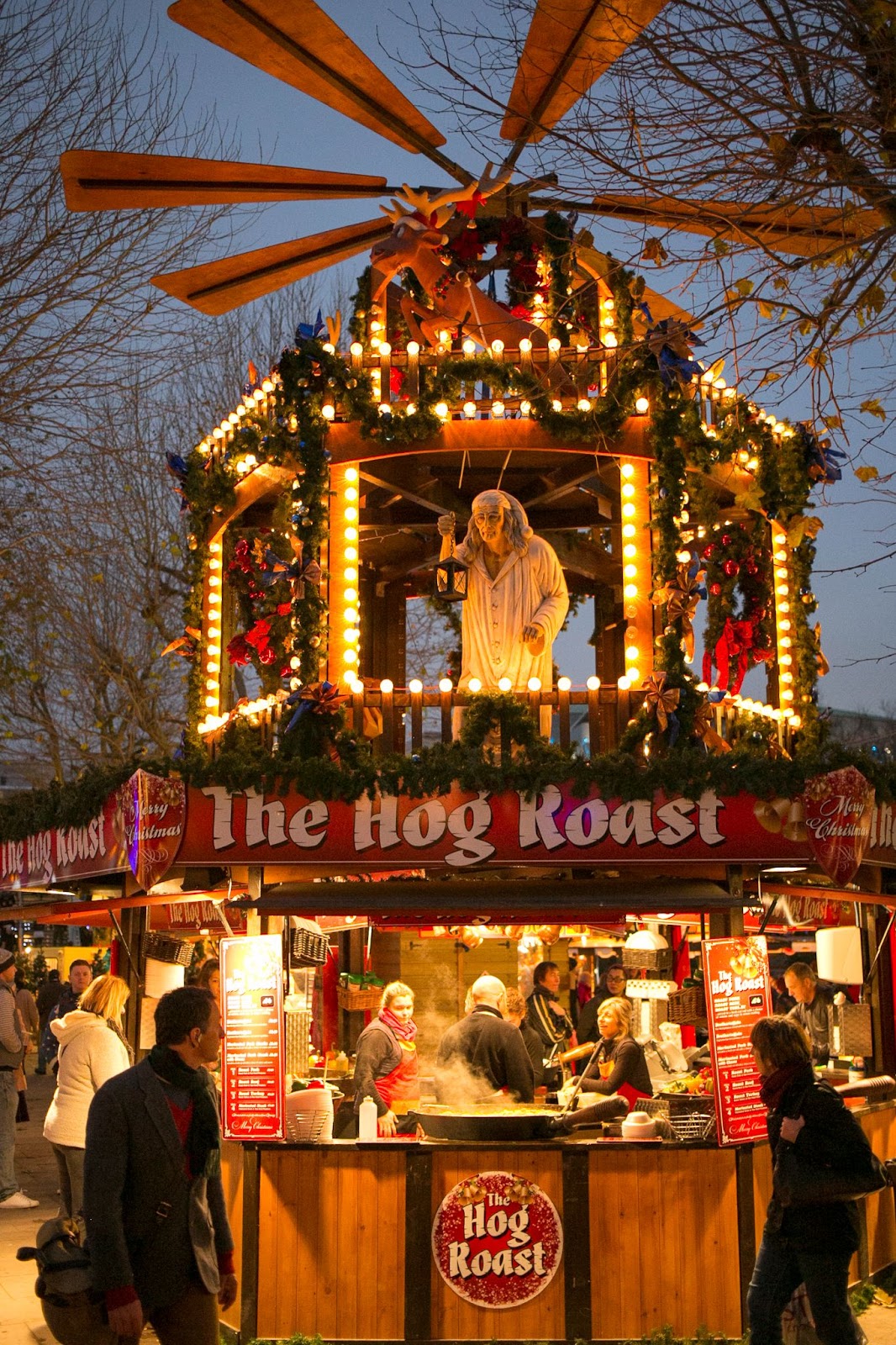 Southbank Centre Winter Market in London with festive stalls, holiday lights, and visitors enjoying seasonal food and drinks by the river.