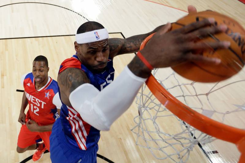 NBA player, LeBron James, dunking a basketball in the all-star game