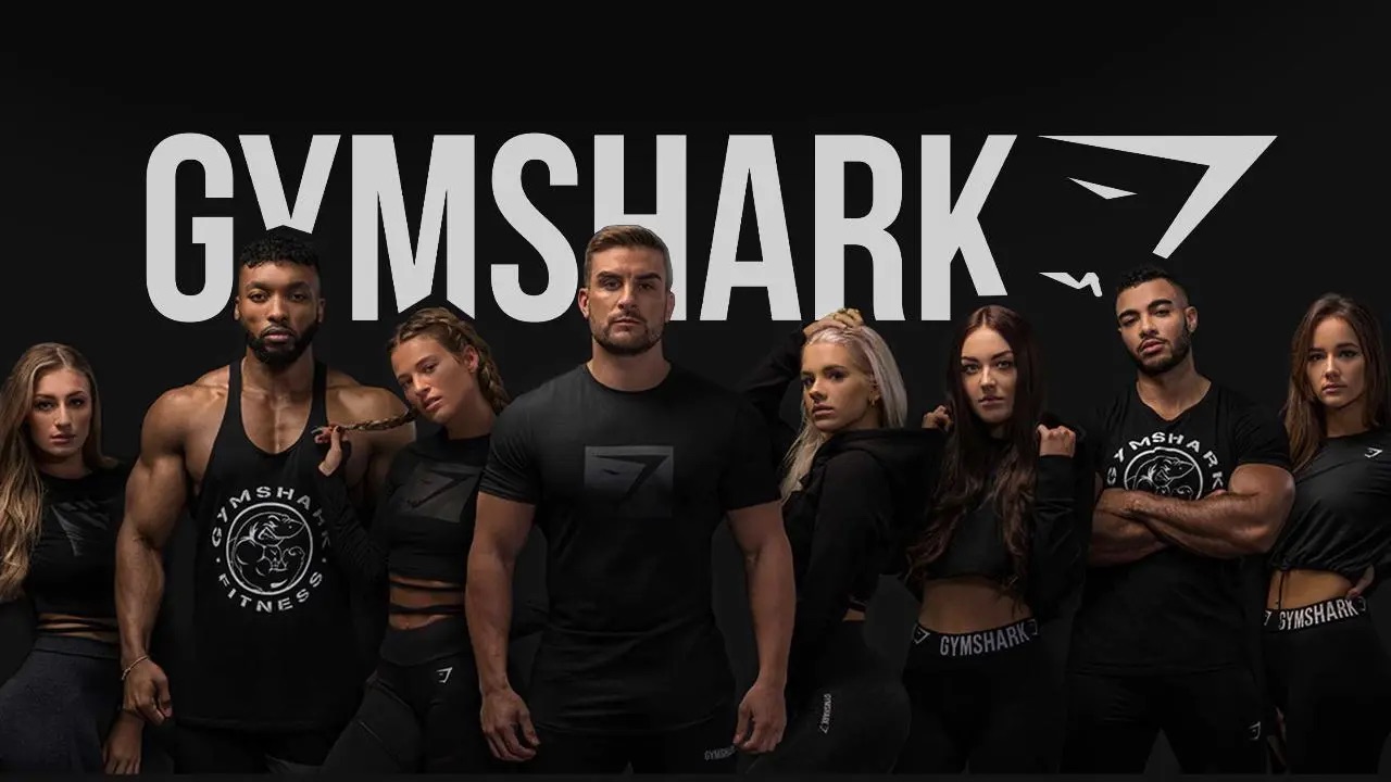 Gymshark influencers standing in a row under logo