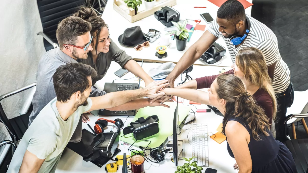 A team of employees enjoying a healthy and happy routine at their workplace by following wellness tips for employees.