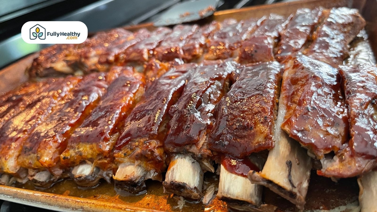 Glazed baby back ribs fresh out of oven on tray