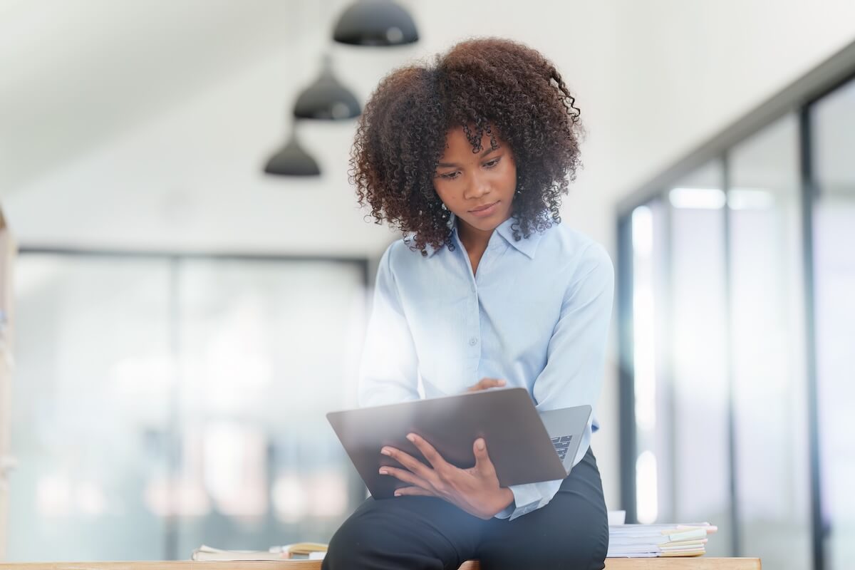 Curly-haired entrepreneur using a laptop