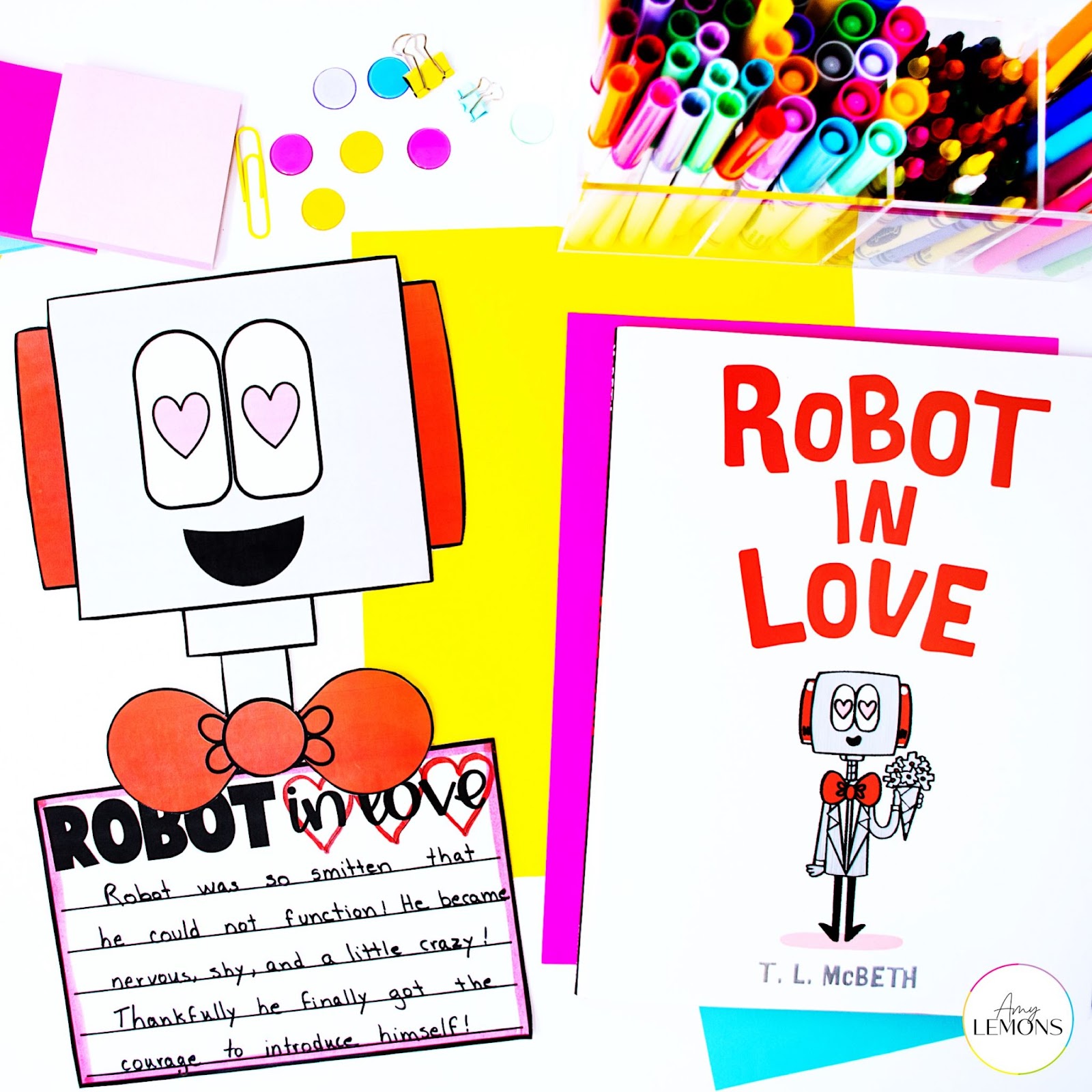 Robot in Love Book with Robot craft, markers and crayons in bin, and colorful papers.