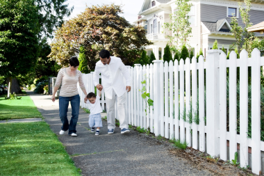 is a full house remodel worth it how to decide if its right for your family couple walking through neighborhood with child custom built michigan