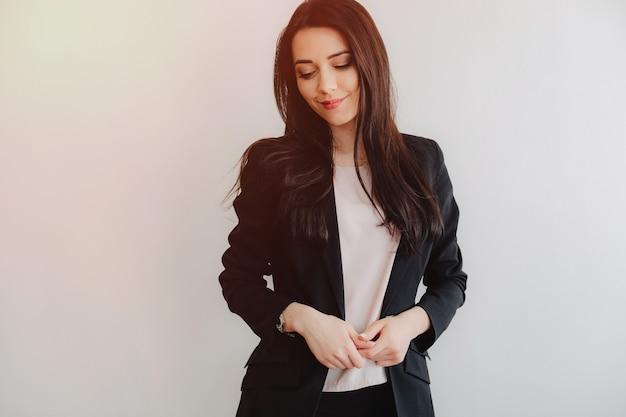 Young attractive emotional girl in businessstyle clothes