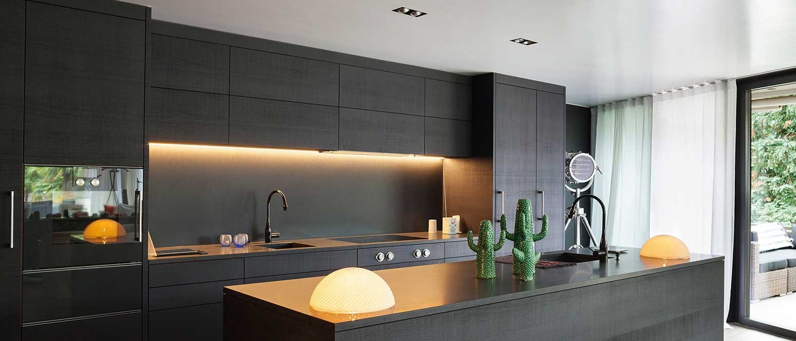 Kitchen countertop illuminated by LED under-cabinet lights.