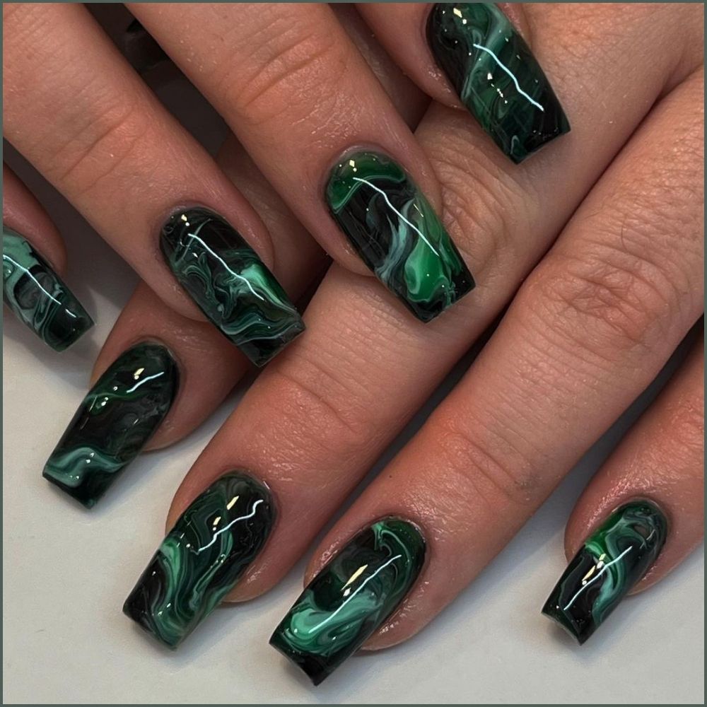 Close up of hands with Christmas Green Nails having  Green Marble Nails