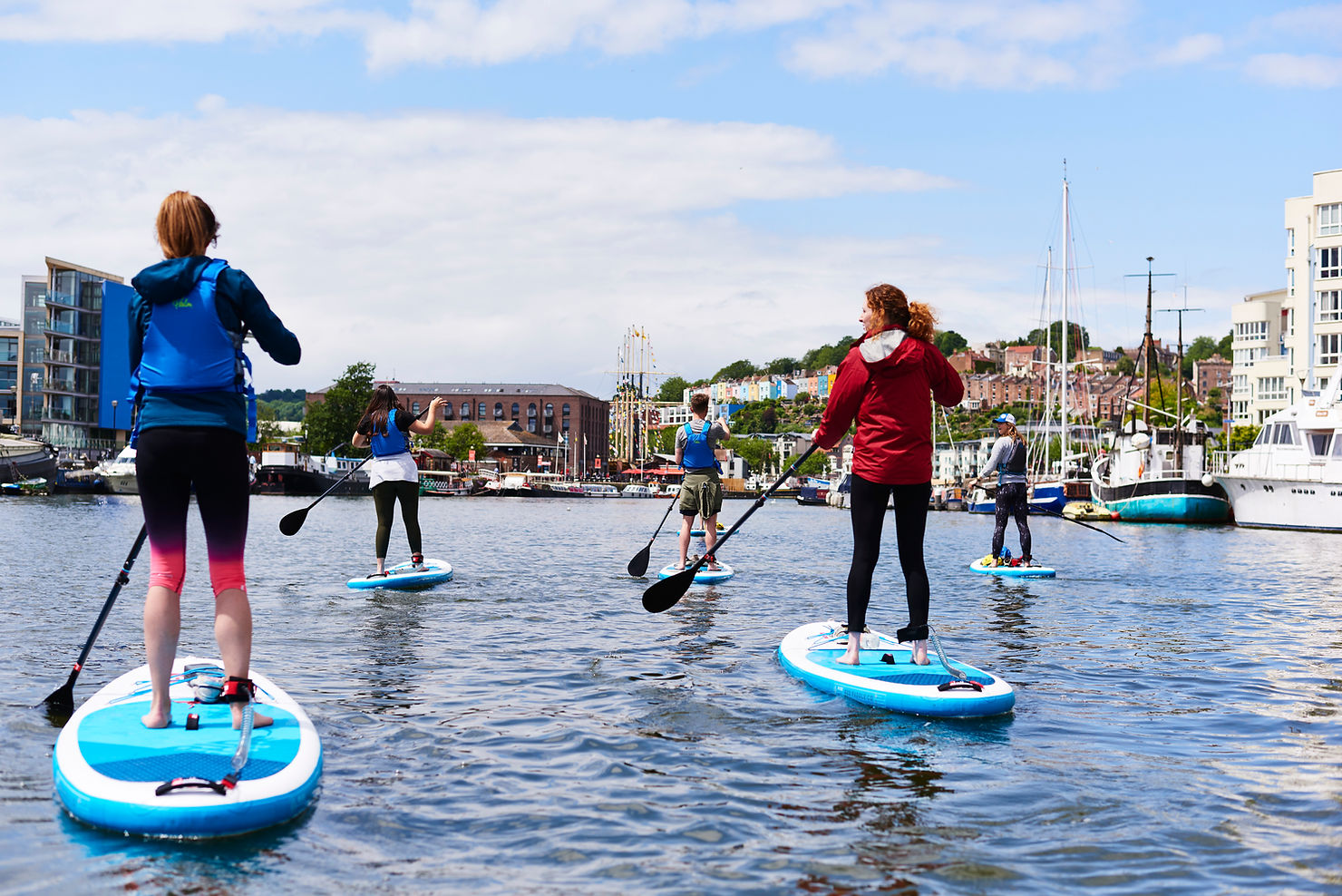 Paddling through Bristol through the harbourside on a Stand Up Paddle Boarding activity session