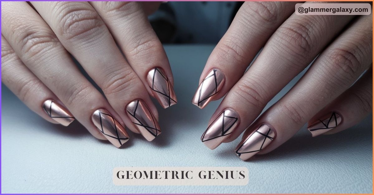 Stiletto nails with rose gold geometric designs on a hand against a grey background.