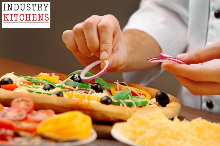 Pizza preparation process with chef carefully arranging fresh toppings on handmade dough