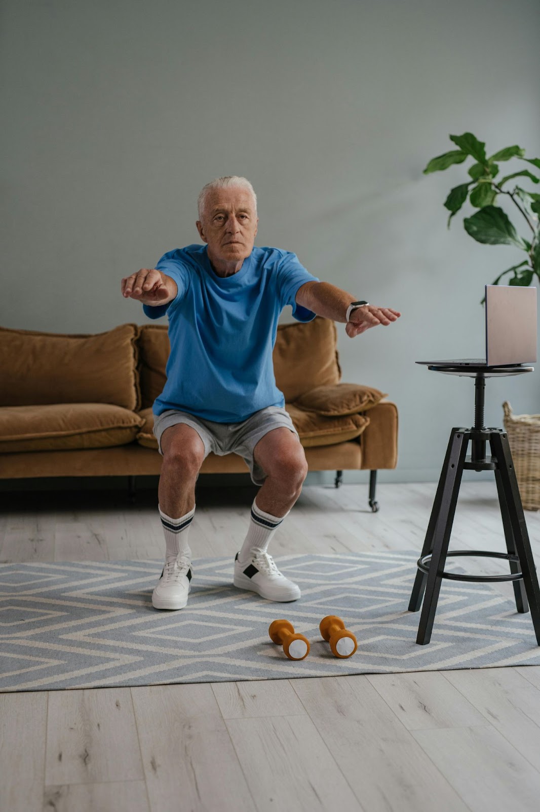 A senior citizen doing a standing squat