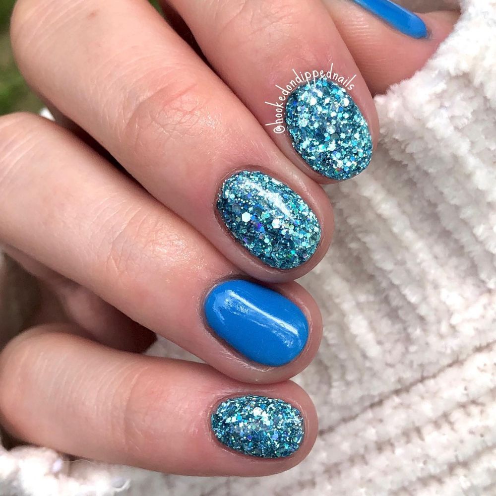 Close up of hands with blue winter nails having Sparks on winter nails