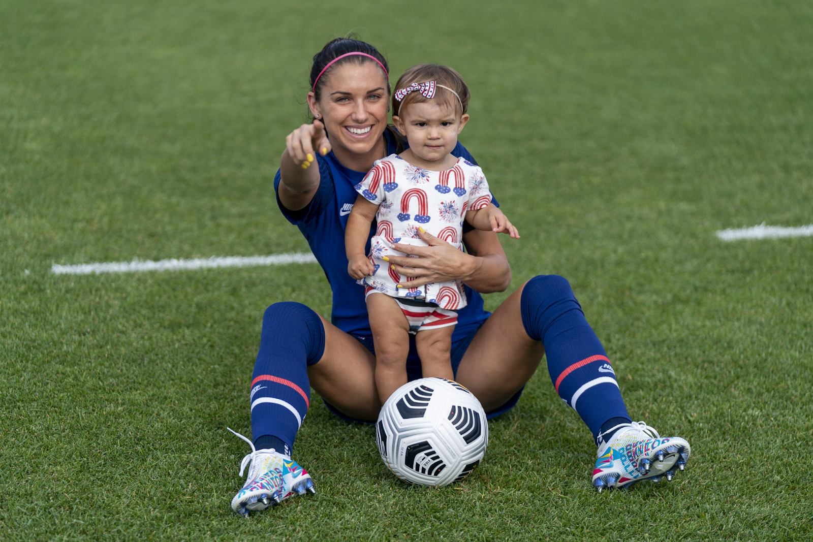 Alex Morgan posing with her daughter