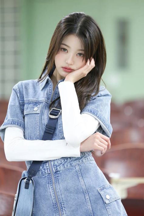 A picture of Wonyoung on a blue jean gown with a white sleeve hand 